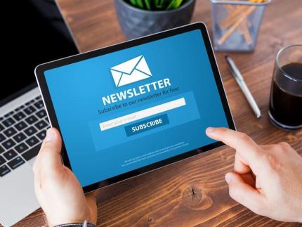 Person subscribing to newsletter on a tablet